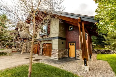 a house with a tree in front of it at Pinnacle Ridge by StayIn in Fernie
