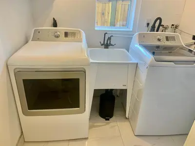 a kitchen with a stove and a sink at Beautiful Two Bedroom Suite in North Vancouver