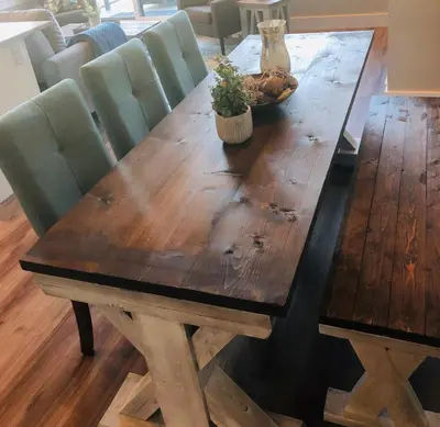 a wooden dining table with green chairs and a wooden table with at Sandy Feet Retreat Port Renfrew- Oceanfront 2BR modern cottage in Port Renfrew