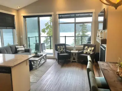 a living room with a couch and chairs and a table at Sandy Feet Retreat Port Renfrew- Oceanfront 2BR modern cottage in Port Renfrew