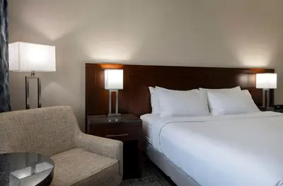a hotel room with a bed and a chair at DoubleTree by Hilton - Kamloops in Kamloops