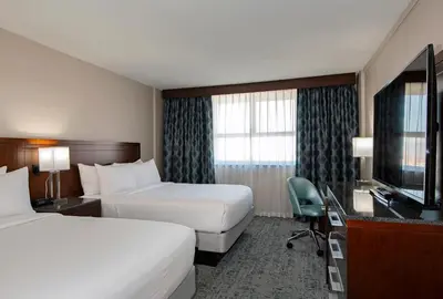 a hotel room with two beds and a flat screen tv at DoubleTree by Hilton - Kamloops in Kamloops