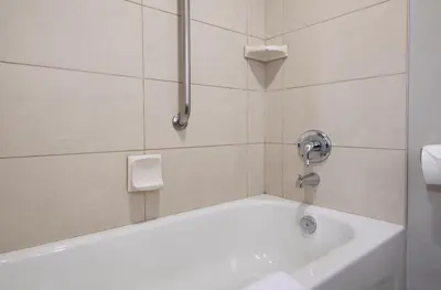 a white bath tub in a bathroom with a shower at DoubleTree by Hilton - Kamloops in Kamloops