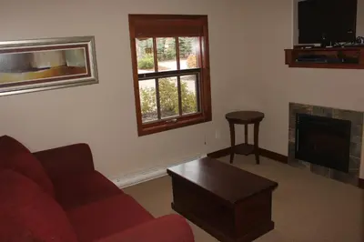 a living room with a couch and a fireplace at Woodhaven # 8 in Sun Peaks in Sun Peaks