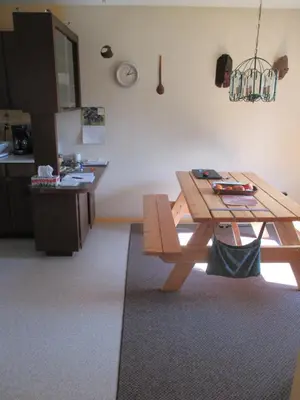 a kitchen with a wooden table and a table sidx sidx sidx at Cabine, Home Sweet Home in Whitehorse