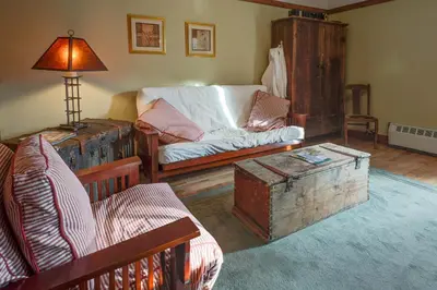 a living room with a couch and a table at Country Encounters Accommodations in Coleman