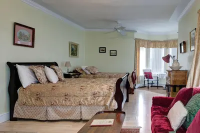 a bedroom with a bed and a table and a couch at Country Encounters Accommodations in Coleman