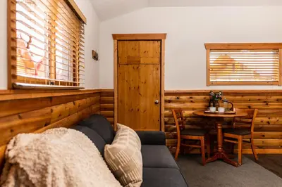 a living room with a couch and a table at Miette Mountain Cabins in Jasper