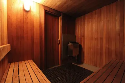 a sauna with a door and a bench in it at Lake Placid Lodge by Whistler Retreats in Whistler