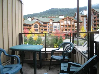 a balcony with a table and chairs and a view at Lake Placid Lodge by Whistler Retreats in Whistler
