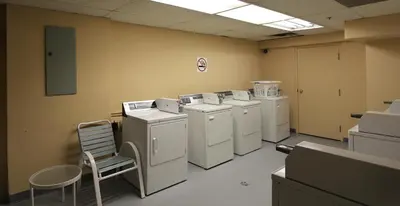 a laundry room with washing machines and a chair at Lake Placid Lodge by Whistler Retreats in Whistler