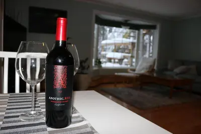 a bottle of wine sitting next to a wine glass at Great Slave Lakeside Bed & Breakfast in Yellowknife