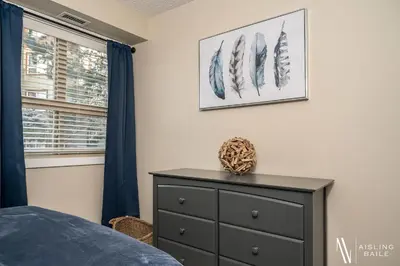 a bedroom with a dresser and a window at Rustic Modern 2 Bed 2 Bath with Lakeview Pool and Hot Tub in Invermere