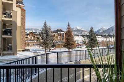 a balcony with a view of a snow covered mountain at Rustic Modern 2 Bed 2 Bath with Lakeview Pool and Hot Tub in Invermere