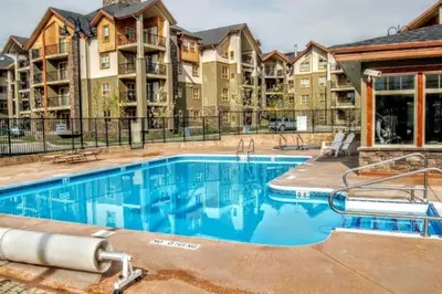 an image of a swimming pool at a apartment complex at Rustic Modern 2 Bed 2 Bath with Lakeview Pool and Hot Tub in Invermere