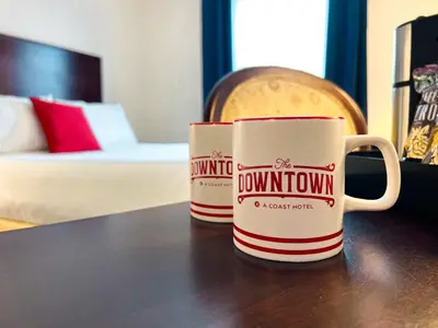 two coffee mugs sitting on top of a table at The Downtown, a Coast Hotel in Dawson City