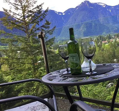 a table with two glasses and a bottle of wine at High Hopes Bed and Breakfast in Hope