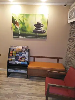 a waiting room with a bench and a table at Sundowner Motel in Cache Creek