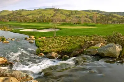 a view of a golf course and a river at Sundowner Motel in Cache Creek