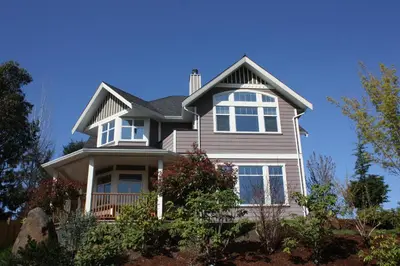a house with white windows and a roof at Eaglenest Manor Cowichan in Duncan