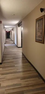 a hallway of an office building with a painting on the wall at New Frontier Hotel in Coronation