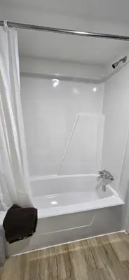 a bathroom with a bath tub with a sink at New Frontier Hotel in Coronation