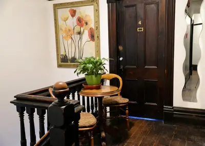 a hallway with a table and chairs and a door at Vancouver Hideaway Guesthouse in Vancouver