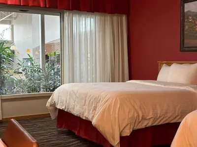 a hotel room with a bed and a window at Westlock Inn & Conference Centre in Westlock