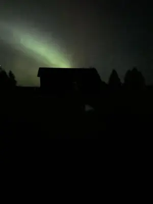 a green light on top of a building in the dark at Sunrise Cabin secluded beach front accommodation in Sandspit