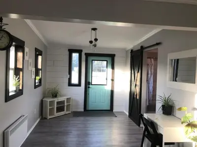 a hallway with a blue door in a house at Sunrise Cabin secluded beach front accommodation in Sandspit