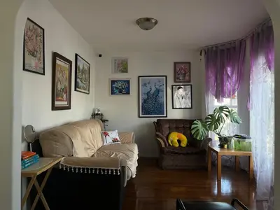 a living room with a couch and a table at Hidden valley treehouse home! in Calgary