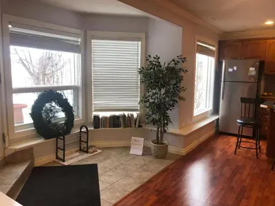 a kitchen with two potted plants and two windows at Hamptons Rose garden family! in Calgary