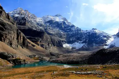 a mountain range with a lake in the foreground at WindTower Resort - 1 Bed Hotel Room 166 in Canmore