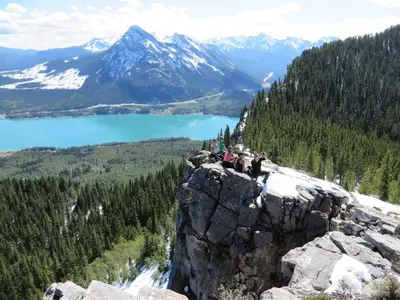 a group of people sitting on top of a mountain at Anniversary and Honeymoon 1 Bedroom Suite 168 in Canmore