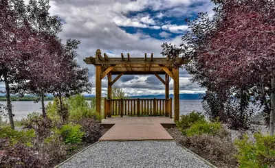 a wooden gazebo sitting next to a body of water at The View Hotel in Fort Saint James
