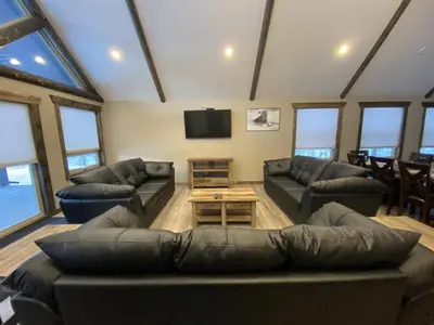 a large living room with couches and a tv at Timber Lodge in Valemount
