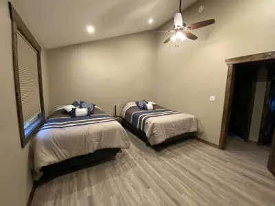 a bedroom with two beds and a ceiling fan at Timber Lodge in Valemount