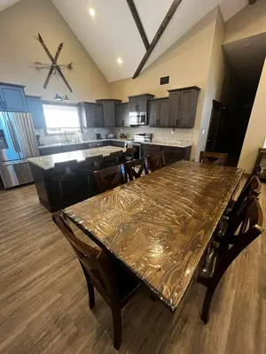 a dining room and kitchen with a table and chairs at Timber Lodge in Valemount