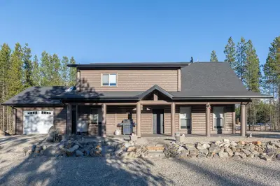 a large house with a gambrel roof at Sunny Peaks in Valemount