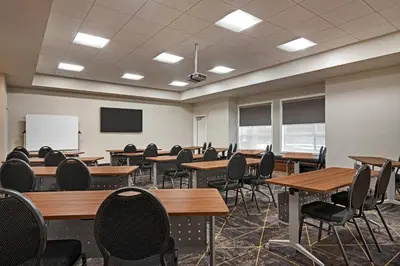 an empty classroom with tables and chairs and a whiteboard at Park Inn by Radisson, Kelowna in Kelowna