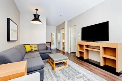a living room with a couch and a flat screen tv at Hyatt Place Kelowna in Kelowna