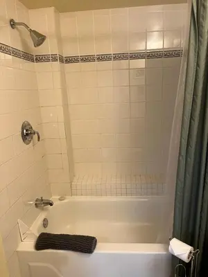 a bathroom with a white tub and a shower at Wildflower Suite in Whistler