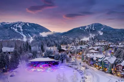 a ski resort in the mountains with snow on the ground at Wildflower Suite in Whistler