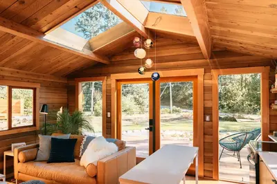 an open living room with a vaulted ceiling at Bodega Ridge & Cove Cabins in Fernwood