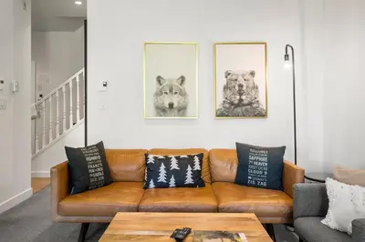 a living room with a brown couch and pictures on the wall at Stoney Creek Northstar by Whistler Premier in Whistler