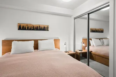 a bedroom with a bed and a mirror at Stoney Creek Northstar by Whistler Premier in Whistler