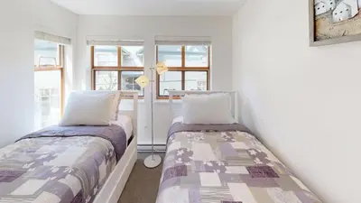 two beds in a room with two windows at Stoney Creek Northstar by Whistler Premier in Whistler