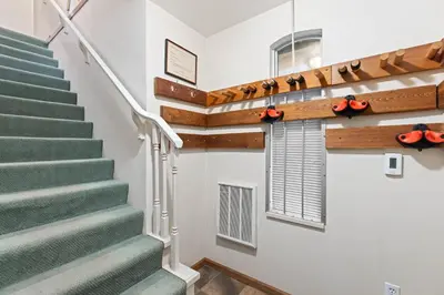 a staircase in a house with green stairs and a window at Stoney Creek Sunpath by Whistler Premier in Whistler
