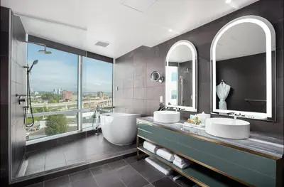 a bathroom with two sinks and two mirrors at Versante Hotel in Richmond