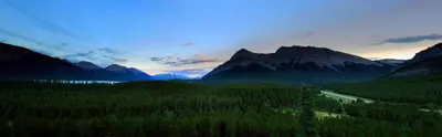 a view of a valley with trees and mountains at David Thompson Resort in Cline River